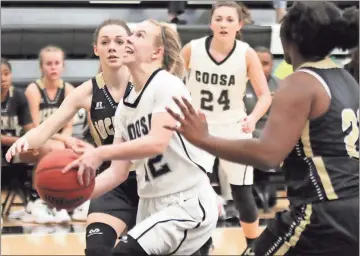  ?? Jeremy Stewart / RN-T ?? Coosa’s Emma Reynolds (center) starts to take a shot while being defended by Rockmart’s Mollie Little (left) and Anbria Daniels during Tuesday’s Region 7-AA game at Coosa High School. Rockmart won 64-56.