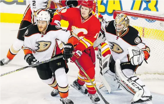  ?? LYLE ASPINALL ?? Matthew Tkachuk and Mikael Backlund of the Calgary Flames mix it up with Korbinian Holzer and Kevin Bieksa of the Anaheim Ducks in front of Jonathan Bernier.