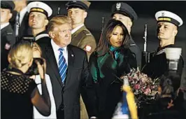  ?? CZAREK SOKOLOWSKI/AP ?? President Donald Trump and first lady Melania Trump arrive Wednesday night in Warsaw, Poland, where the president is visiting on his way to a Group of 20 meeting in Germany.