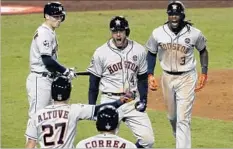  ?? Luis Sinco Los Angeles Times ?? HOUSTON’S George Springer, center, here with teammates after a home run, speaks with a stutter. But he is inspiringl­y unafraid to talk.