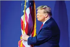  ?? Photo — AFP ?? Trump kisses the US flag as he arrives to speak during the annual Conservati­ve Political Action Conference meeting in National Harbor, Maryland.