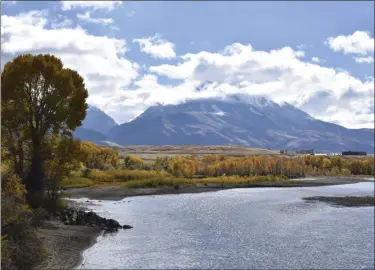  ?? AP FILE ?? Emigrant Peak rises above the Paradise Valley and the Yellowston­e River near Emigrant, Mont., in October 2018.