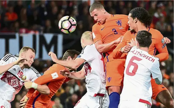  ?? — AFP ?? A cool head: Holland’s Jeffrey Bruma (third from right) heading the ball during the World Cup qualifiyin­g match against Belarus at the Feyenoord Stadium in Rotterdam on Friday.