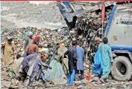  ?? —AP ?? Afghan refugees scavenge for recyclable material from garbage, mostly plastic shopping bags and bottles, to earn a living for his family, in Karachi, Pakistan, on Saturday.