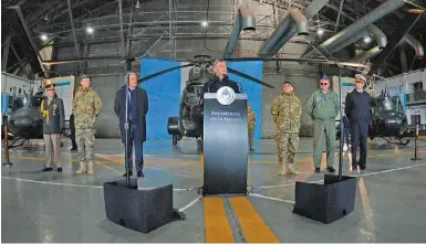  ?? PRESIDENCY ?? President Mauricio Macri, backed by Defence Minister Oscar Aguard and members of the Armed Forces, delivers a speech at a military base near Buenos Aires on Monday.