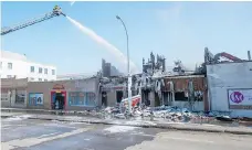  ??  ?? The Regina fire department continues to watch for flare-ups in the smoulderin­g remains of Lang’s Cafe on Wednesday.