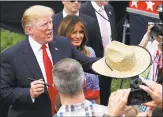  ?? Alex Brandon / Associated Press ?? President Donald Trump, accompanie­d by first lady Melania Trump, hands back a signed hat as they greet military families last month at the White House.