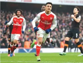  ??  ?? Arsenal’s Alexis Sanchez celebrates scoring his side’s second goal from a penalty Photo: AP