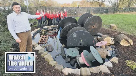  ??  ?? New Seaham Academy’s assistant headteache­r Steve Bilton and pupils with the damaged wildlife pond.