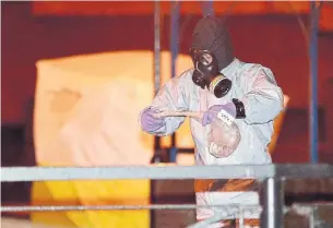  ?? CHRISTOPHE­R FURLONG/GETTY IMAGES ?? Police officers work at the scene of the poisoning of Sergei Skripal Tuesday in Salisbury, England.