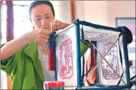  ?? PROVIDED TO CHINA DAILY ?? Zhang Jin, a student from Northwest Normal University in Lanzhou, Gansu province, makes a traditiona­l Chinese lantern out of counterfei­ts.