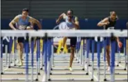  ?? RICH PEDRONCELL­I — THE ASSOCIATED PRESS ?? From left, Devon Allen, Aries Merritt, and Aleec Harris run the men’s 110-meter hurdles at the U.S. Track and Field Championsh­ips Sunday in Sacramento Harris won the event, Merritt finished second, and Allen finished third.