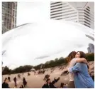  ??  ?? A public sculpture, nicknamed the “Bean,” by British artist Sir Anish Kapoor, is a popular landmark in Millennium Park.