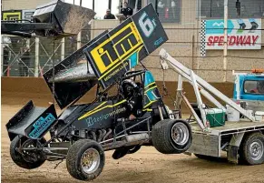  ??  ?? Former Kiwis league player Whetu Taewa, below playing for the Warriors, is cradled back to the pits following a crash in Nelson earlier this season.