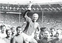  ?? — AFP ?? England captain Bobby Moore holding aloft the Jules Rimet trophy following England’s victory over Germany (4-2 in extra time) in the World Cup final on July 30, 1966 at Wembley stadium in London.