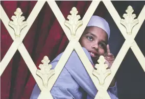  ?? MANISH SWARUP, THE ASSOCIATED PRESS ?? A boy looks out from the window of a mosque before Friday prayers in Colombo, Sri Lanka. The country remains on high alert following the Easter Sunday attacks, which claimed the lives of more than 250 people.