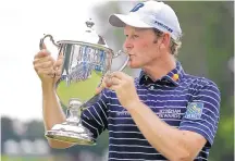  ?? CHUCK BURTON/ASSOCIATED PRESS ?? Brandt Snedeker kisses the trophy after winning the Wyndham Championsh­ip on Sunday. Snedeker, who shot 59 in the opening round on Thursday, closed with a 65.