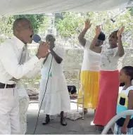  ??  ?? Pastor Royston Donaldson worships with his congregati­on.