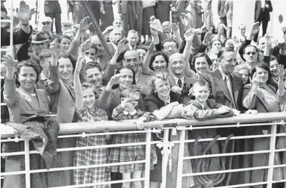  ?? /AP ?? German Jewish refugees return to Antwerp, Belgium, in 1939 aboard the St. Louis after they had been denied entrance to Cuba and the United States. More than 76 years later, fresh angst about whether to admit refugees or turn them away has put the...