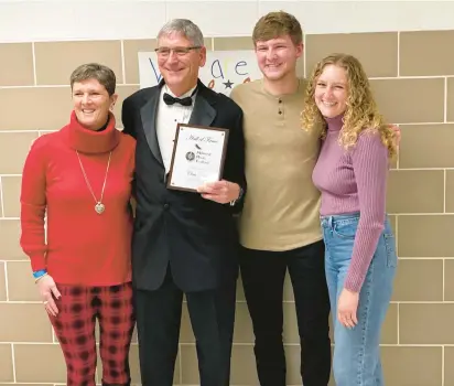  ?? SCHOOL DISTRICT 218 PHOTOS ?? Chris Pitlik, band director at Shepard High School in Palos Heights, stands with his family after receiving the Lifetime Achievemen­t Award from the Midwest Music Festival in Lemont.