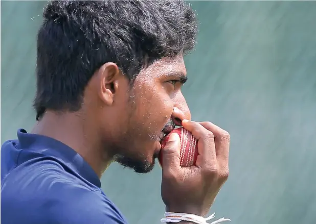  ?? AP ?? Sri Lankan spinner Lakshan Sandakan bites the ball during a training session in anticipati­on of a spin friendly wicket for the second Test against South Africa in Colombo on Thursday. —