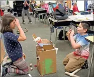  ?? Kelcey Caulder ?? Jennifer Holley’s fourth grade class used their knowledge of simple machines to create arcade games like this basketball shooter during Monday’s STEM Day.