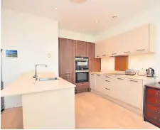  ?? ?? Modern The kitchen is neutrally decorated and boasts statement appliances