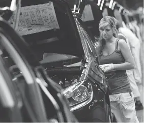  ??  ?? SEAN GALLUP / GETTY IMAGES A female worker on a VW assembly line in Germany. One of the predominan­t themes of the latest Canadian federal budget is increasing the workforce participat­ion of women.