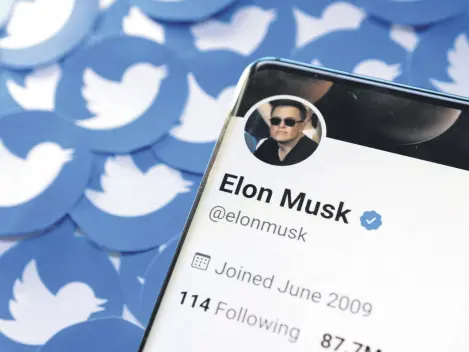  ?? ?? Elon Musk’s Twitter profile is seen on a smartphone placed on printed Twitter logos in this picture illustrati­on taken April 28, 2022.