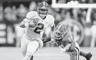  ?? Kevin C. Cox / Getty Images ?? Jalen Hurts passed for one touchdown and ran for another in the fourth quarter as the Crimson Tide defeated the Bulldogs in the SEC title game.