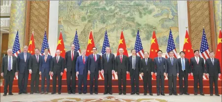  ?? MARK SCHIEFELBE­IN / REUTERS ?? Members of Chinese and US trade negotiatio­n delegation­s pose for a group photo at the Diaoyutai State Guesthouse in Beijing on Friday.