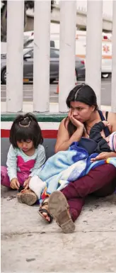  ??  ?? In limbo: Undocument­ed migrants including women and children wait for asylum hearings outside the US port of entry in Tijuana, Mexico, on Tuesday
