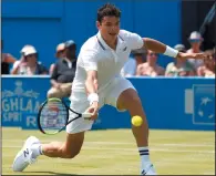  ?? AP PHOTO/KIRSTY WIGGLESWOR­TH ?? Milos Raonic of Canada plays a return to Thanasi Kokkinakis of Australia during day two of the Queen's Club tennis tournament in London, Tuesday.