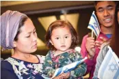  ??  ?? NURIT HAOKIP and her 18-month-old daughter Revital celebrate at Ben-Gurion Airport after making aliya this week from India.