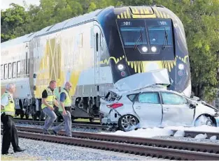  ?? AMY BETH BENNETT/SUN SENTINEL ?? A Brightline train crashed Wednesday into an unoccupied SUV that was disabled on the tracks south of Pembroke Road in Hallandale Beach.