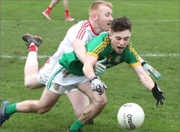  ??  ?? Louth’s Philip Englishby concedes a penalty by taking down Meath’s James Conlon.