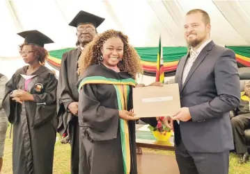  ?? Fungai Lupande — Picture: ?? Lands, Agricultur­e, Fisheries, Water and Rural Developmen­t Deputy Minister Vangelis Haritatos presents an award to one of the top students Melina Njanji at Shamva Agricultur­al College’s10th graduation ceremony on Friday.