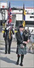  ?? 01_B13dasher0­1 ?? Piper Ian Clarke leads the flag bearers off the ferry to take part in the memorial service for HMS Dasher.