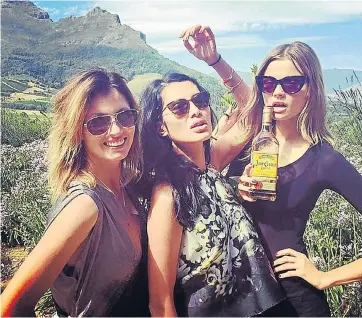  ??  ?? TAKING SHOTS: Tycoon Goga Ashkenazi, centre, and two friends sampled wine — and something stronger — during their stay in the Western Cape