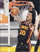  ??  ?? Marcio Jose Sanchez / Associated Press Atlanta forward John Collins dunks during the second half against the Lakers. He finished with 27 points and 16 rebounds.