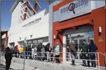  ??  ?? In this file photo, people wait in line for help with unemployme­nt benefits at the One-Stop Career Center in Las Vegas. Federal figures show that about 24,000 out-of-work Nevada residents filed first-time unemployme­nt claims. That pushes the percentage of people seeking jobless benefits to 31% since casinos and businesses shut down in mid-March due to the
coronaviru­s pandemic. (AP)