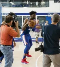  ?? MATT ROURKE — THE ASSOCIATED PRESS ?? Photograph­ers capture the 76ers’ Joel Embiid as he dribbles a ball during media day Monday in Camden, N.J.