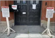  ?? TANIA BARRICKLO — DAILY FREEMAN ?? Signs in from of the side door at Kingston City Hall, shown on Thursday, June 11, notify the public that the building is closed. That will change on June 22.