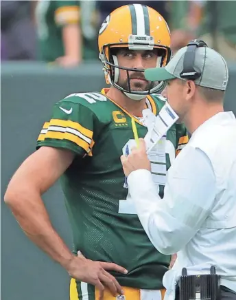  ?? MARK HOFFMAN / JOURNAL SENTINEL ?? Packers quarterbac­k Aaron Rodgers and Matt LaFleur talk during the third quarter Sunday.