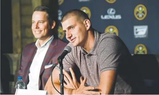  ?? Joe Amon, The Denver Post ?? Nikola Jokic, right, flanked by Nuggets president Josh Kroenke, takes a question Monday during a news conference after signing the richest contract in team history — $147.7 million over five years. Jokic, 23, is going into his fourth season in the NBA.