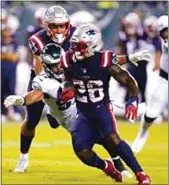  ?? CHRIS SZAGOLA / AP ?? Patriots running back Sony Michel runs with the ball as the Eagles’ T.J. Edwards tries to bring him down during the first half of last week’s NFL preseason game in Philadelph­ia. Michel was traded to the Rams on Wednesday.