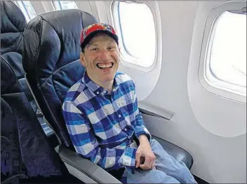  ?? SUBMITTED ?? Douglas Butler was happy to share his gift for making people smile with folks he encountere­d during a dream-cometrue trip that entailed a flight on a real, big airplane.