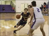  ?? JENNIFER FORBUS — FOR THE MORNING JOURNAL ?? North Ridgeville’s Nate Theus tries to drive past the defense of Keystone’s Ryan Walsh to get to the basket.