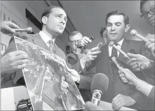  ?? UPI/Bettmann Newsphotos ?? PROSECUTOR­S Aaron Stovitz, left, and Vincent Bugliosi speak to reporters before a grand jury hearing. Bugliosi’s 1974 book on the case, “Helter Skelter,” has never gone out of print.