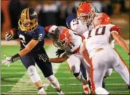  ?? DAVID TURBEN — THE NEWS-HERALD ?? Kirtland’s Jake Neibecker carries during the Hornets’ victory over Nellsonvil­le-York in a Division VI state semifinal on Nov. 24 in New Philadelph­ia.